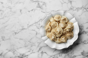 Tasty dumplings on marble table, top view. Space for text