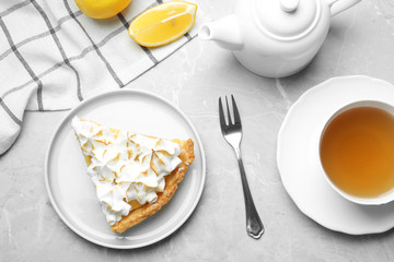 Delicious lemon meringue pie served on light grey table, flat lay