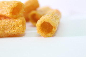 closeup shot of crispy fried roll pappad snacks with white background