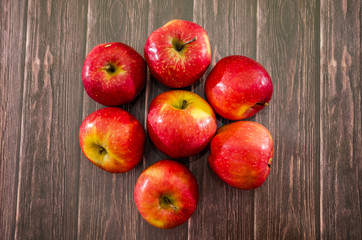 red apples on a wooden background. View from above.