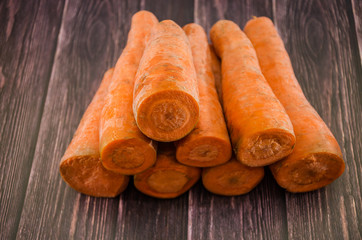 a lot of carrots on a wooden background