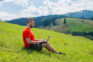 Naklejka na ściany i meble Workaholic man working on laptop during vacation, remote work.