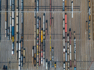 Aerial view of freight train wagons on large railway track field. Concept of modern logistics.