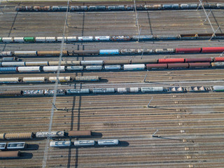 Aerial view of freight train wagons on large railway track field. Concept of modern logistics.