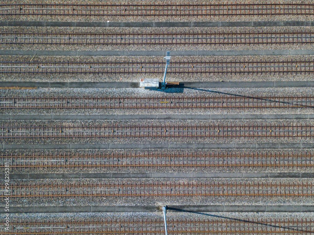 Wall mural Aerial view of freight train wagons on large railway track field. Concept of modern logistics.