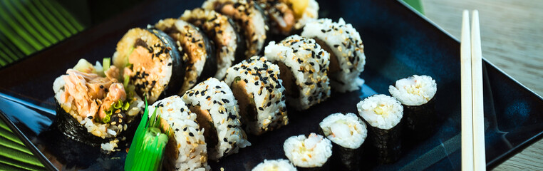 Japanese sushi set. Maki and rolls with tuna, salmon, shrimp, mango, crab and avocado