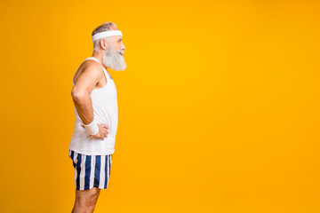 Profile photo of aged model white hair guy visit gym listening trainer motivated person group yoga wear tank-top striped shorts sweatband isolated yellow color background
