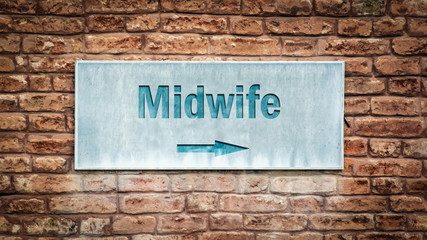 Fototapeta na wymiar Street Sign to Midwife