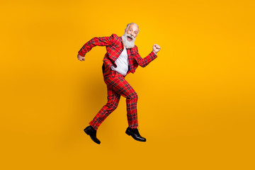 Fototapeta na wymiar Full length body size view of his he nice handsome cheerful cheery funky comic childish gray-haired man jumping having fun running isolated over bright vivid shine vibrant yellow color background