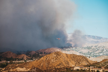 Helicopter flies through the wildfire smoke. Tick Fire in Santa Clarita, CA