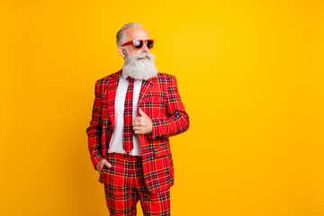 Fototapeta na wymiar Photo of cool grandpa white beard model guy standing self-confidently posing for magazine cover wear sun specs tartan red costume outfit isolated yellow color background