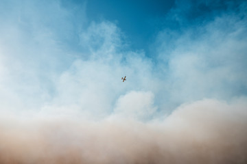 Airplane flies through the wildfire smoke. Tick Fire in Santa Clarita, CA