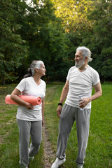 Beautiful senior couple working out together in the nature