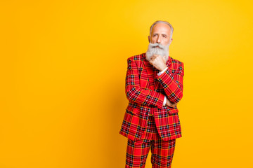Photo of cool modern grandpa model guy deep thinking hand on chin looking empty space wear red gingham blazer tie trousers clothes isolated yellow color background
