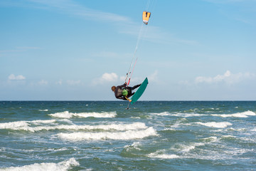Jump of a Kiteboarder in the Baltic Sea at the beach of Flügge on the island Fehmarn in the north...