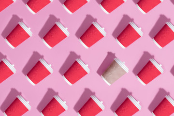 Pattern of paper cups on pink background.