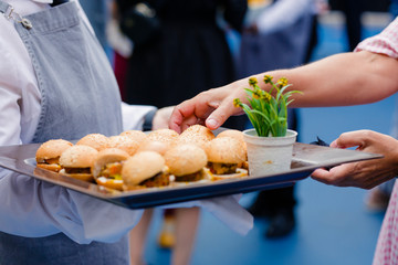 Waiter serving food in cocktail