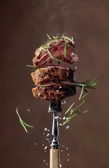 Foto op Canvas Grilled ribeye beef steak with rosemary on a brown background. © Igor Normann