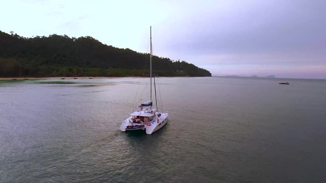 ARIAL: sailboat by a beach in thailand