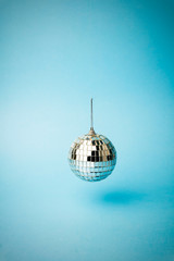 Disco ball on a colored blue background. Minimal concept