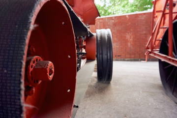 metal wheels without tires on a very old tractor of the early 20th century in an open-air museum