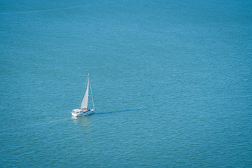 A sailboat on the sea in a sunny day