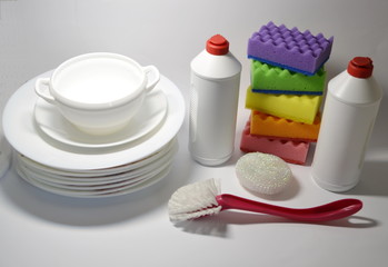  On a white background plates, dishwashing liquid, washcloths, brush.