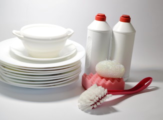 On a white background plates, dishwashing liquid, washcloths, brush.