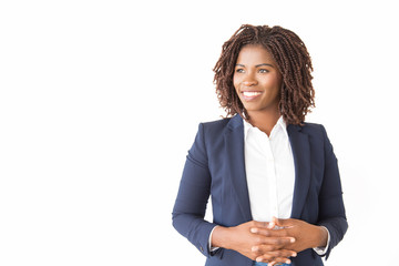 Happy female business leader posing with clasped hands. Young black business woman standing...