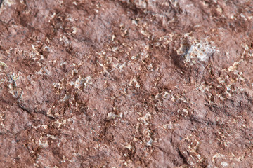 Grainy red stone texture. Natural backgrounds and textures. Decor and design. Top view.
