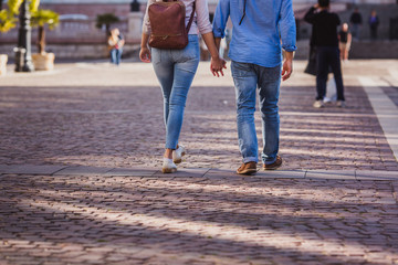 Tourist couple walking on cobblestone street vacation in europe on holiday break