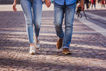 Tourist couple walking on cobblestone street vacation in europe on holiday break