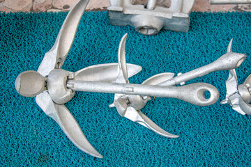 Close up of small kayak anchors in front of store.