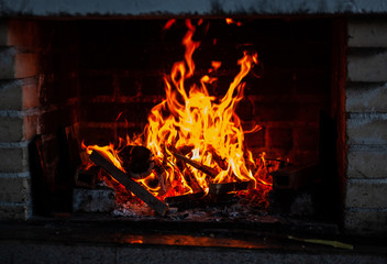 Flame on burning wood in fireplace