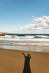 human shadow on sand beach in corsica