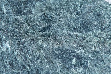 Grainy texture of greenish-gray natural stone. Natural backgrounds and textures.