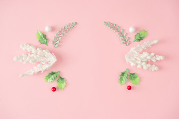 Christmas composition. Fir tree branches, white decorations on pink background. Christmas, winter, new year concept. Minimal flat lay, top view.