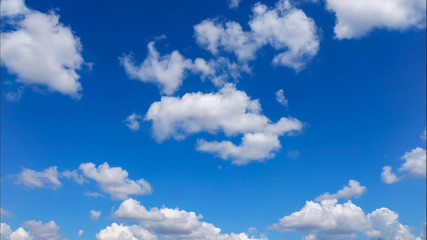 puffy white lightness clouds on blue sky, close-up
