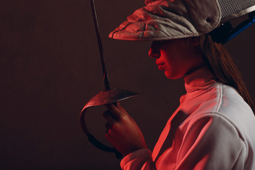 Fencer woman profile portrait with fencing sword.