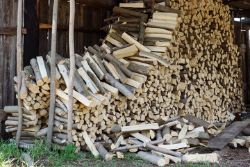 Fallen firewood stack in shed close up