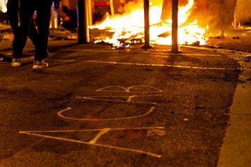 Barcelona, Spain - 16 october 2019: acab word on asphalt street wih fire in the background during...