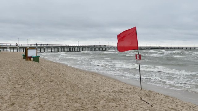 Red warning flag forbidding to swim on the beach in Palanga, Lithuania.