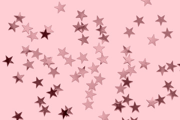 Star confetti on paper tined pastel pink - monochrome Christmas background