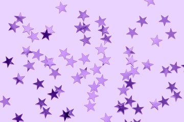 Purple star confetti on a pastel purple background- monochrome Christmas festive backdrop