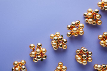 top view of shiny golden Christmas decoration on blue background with copy space