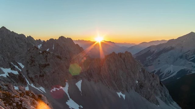 Timelapse of a beautiful sunset in the mountains. No clouds and incredible color transitions. Alpine landscape.