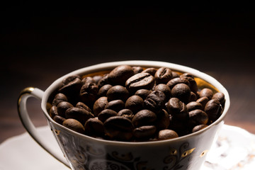 Fototapeta premium coffee bean filled mug , close up . coffee beans background 