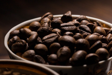  coffee bean filled mug , close up . coffee beans background 