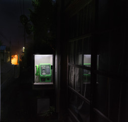 Old street phone booth in Japan, screen and dial, night scene 