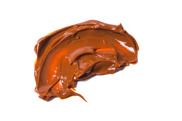 Melted tasty caramel splashes isolated on white background.
